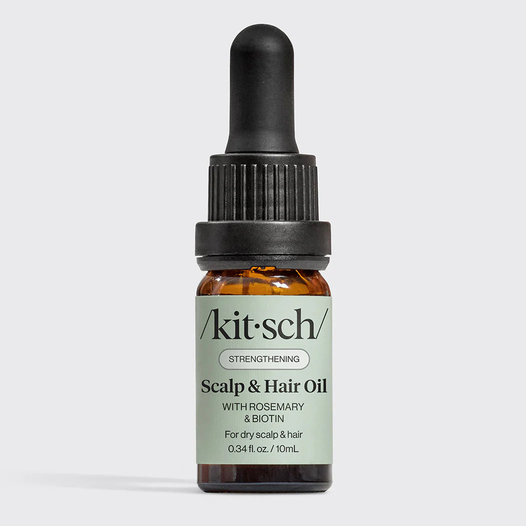 Kitsch scalp and hair oil bottle with dropper on a light gray background