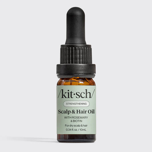 Kitsch scalp and hair oil bottle with dropper on a light gray background