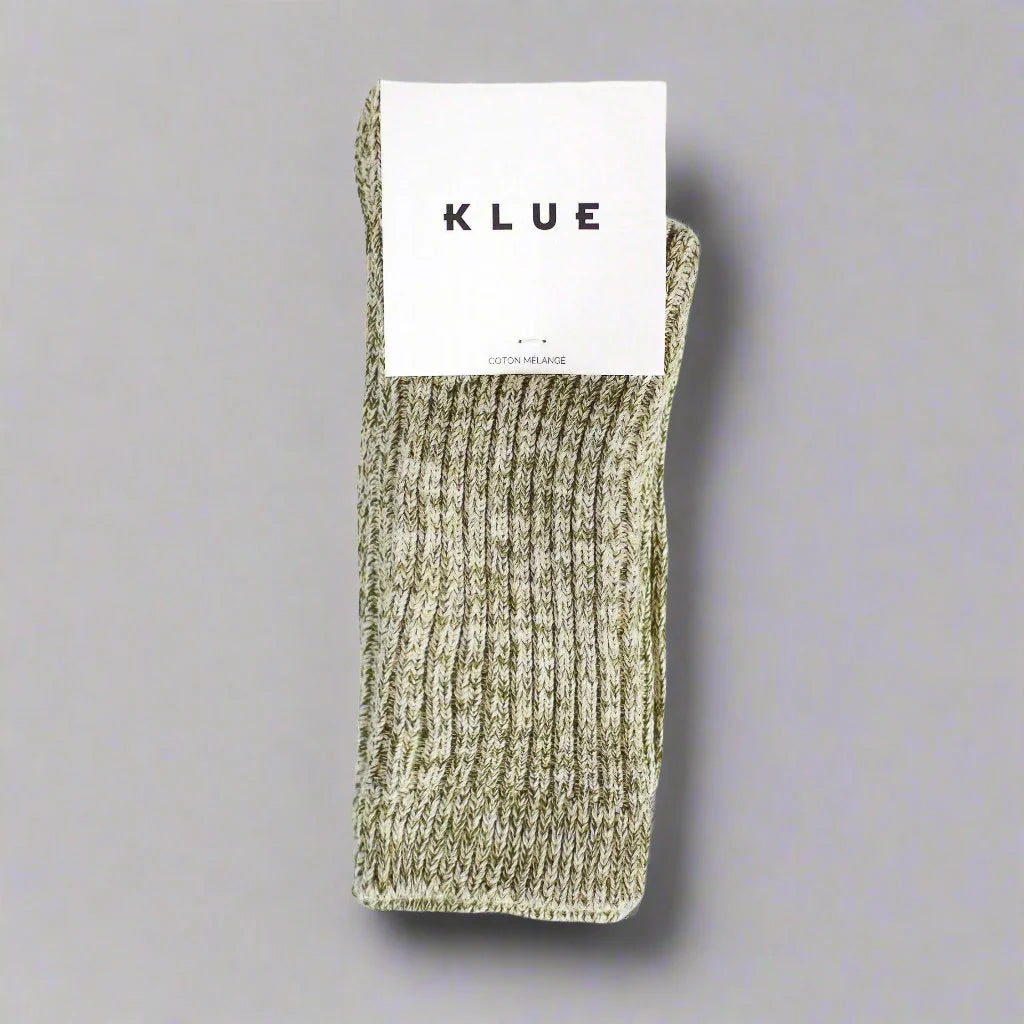 Green sock with a KLUE label on a gray background