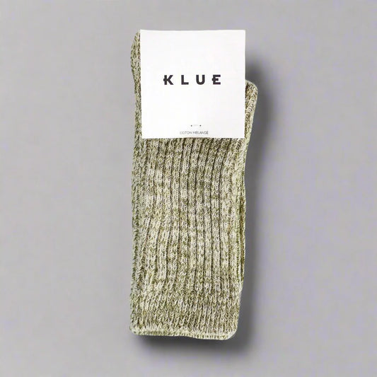 Green sock with a KLUE label on a gray background