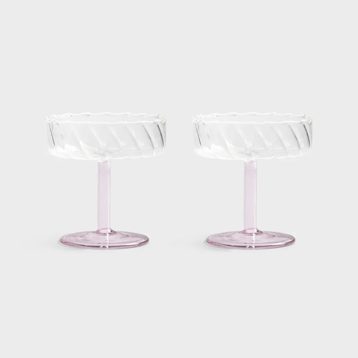 Two clear glass dessert stands on a white background
