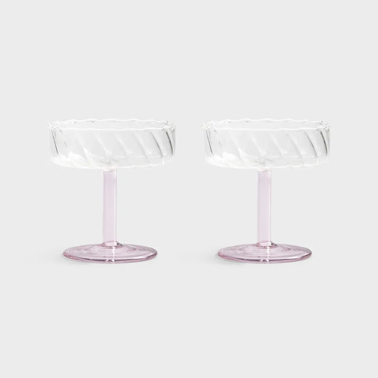 Two clear glass dessert stands on a white background