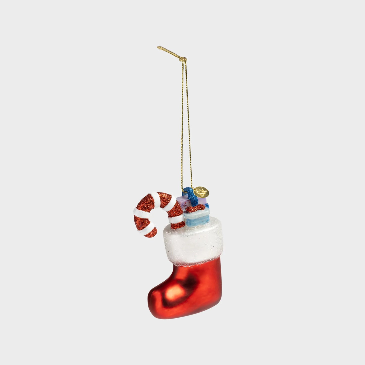 Christmas ornament shaped like a red stocking with candy cane and presents on a white background