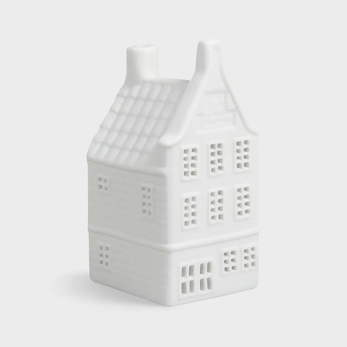 White house-shaped ceramic lantern on a light gray background