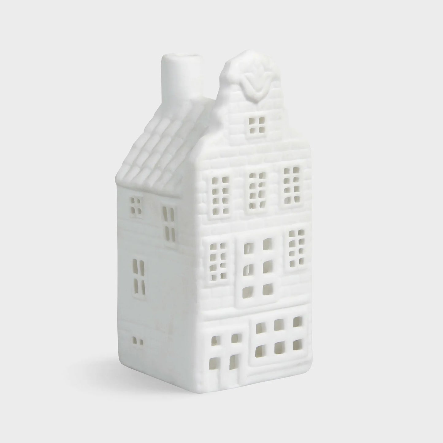 White ceramic house-shaped lantern on a light gray background