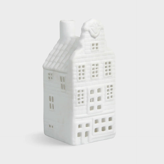 White ceramic house-shaped lantern on a light gray background