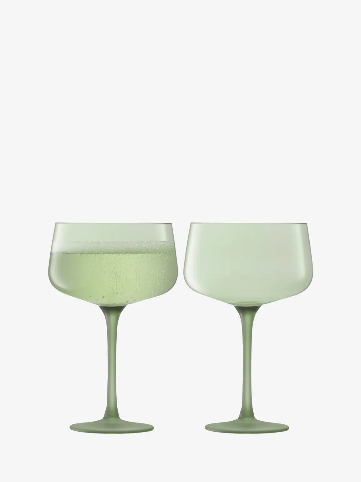Two green wine glasses on a white background