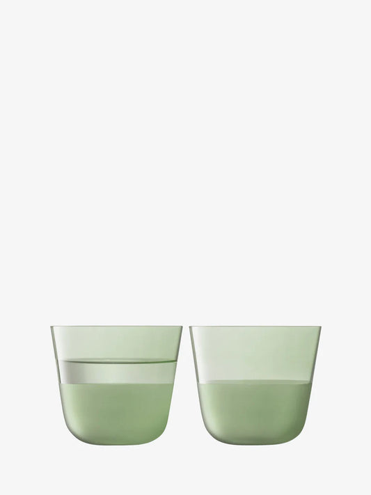 Two green glass tumblers on a white background