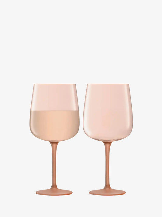 Two pink wine glasses on a white background