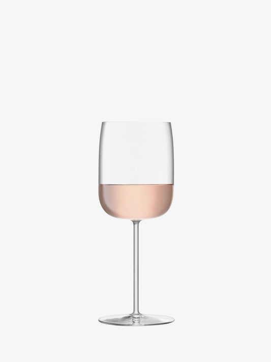 Wine glass with pink wine on a white background