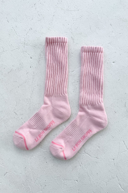 Pair of pink socks with text on a light gray background