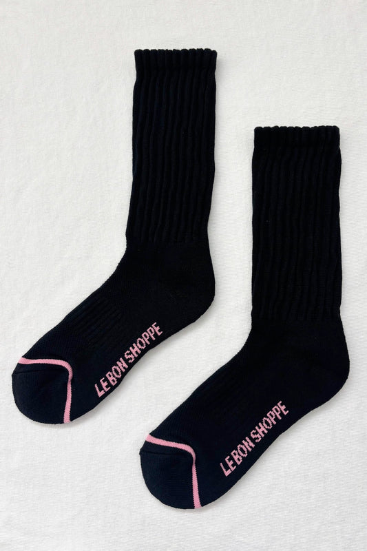 Black socks with pink trim and 'LEBON SHOPPE' branding on a light gray background