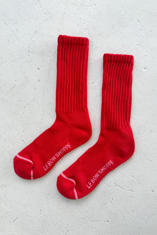 Red socks with white text on a light gray background