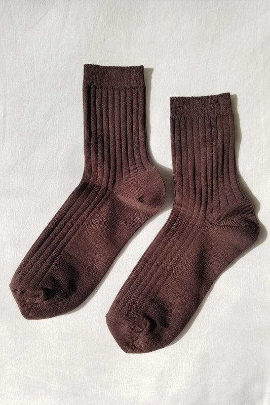 Pair of brown socks on a light gray background