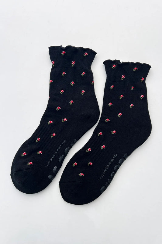 Black socks with pink patterns on a white background