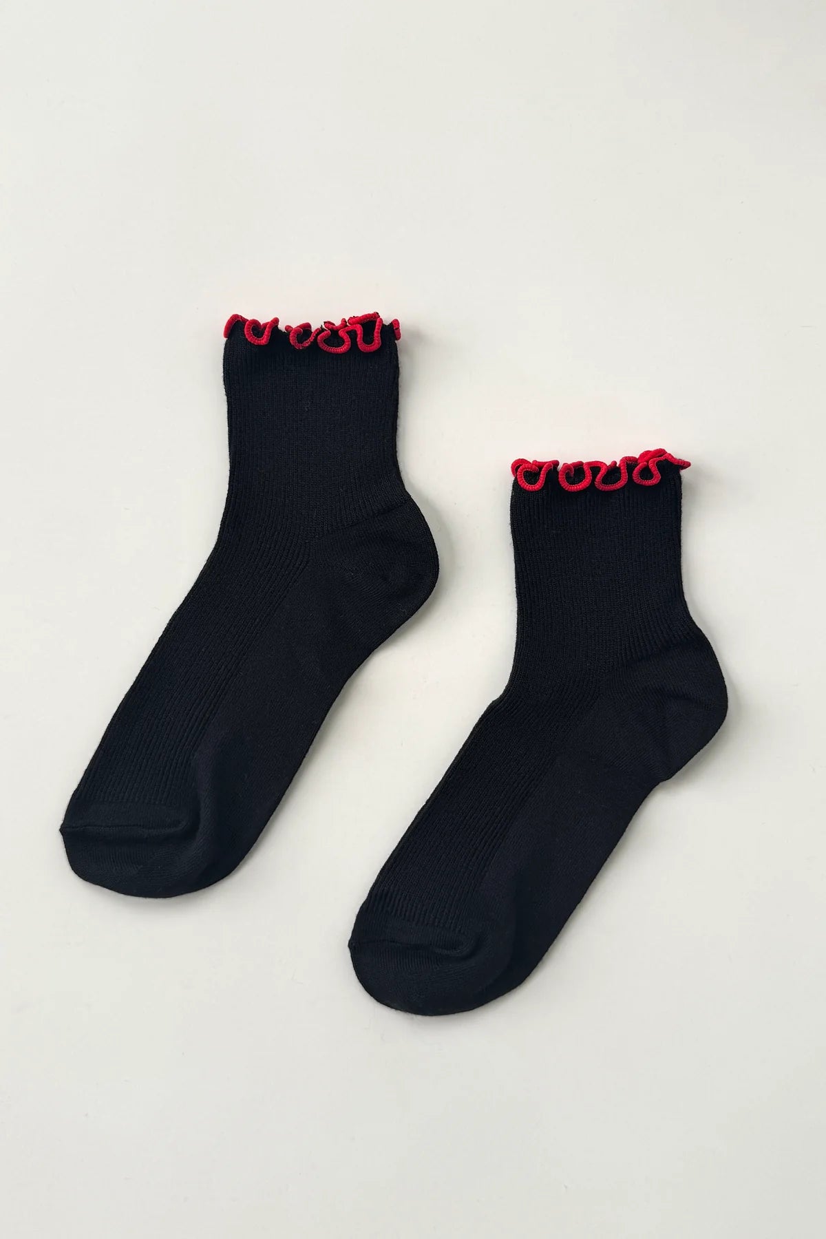 Black socks with red trim on a light gray background