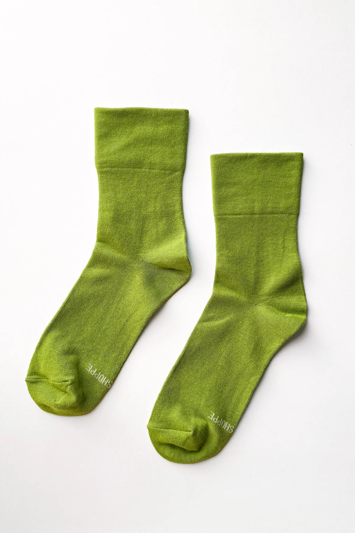 Pair of green socks on a white background