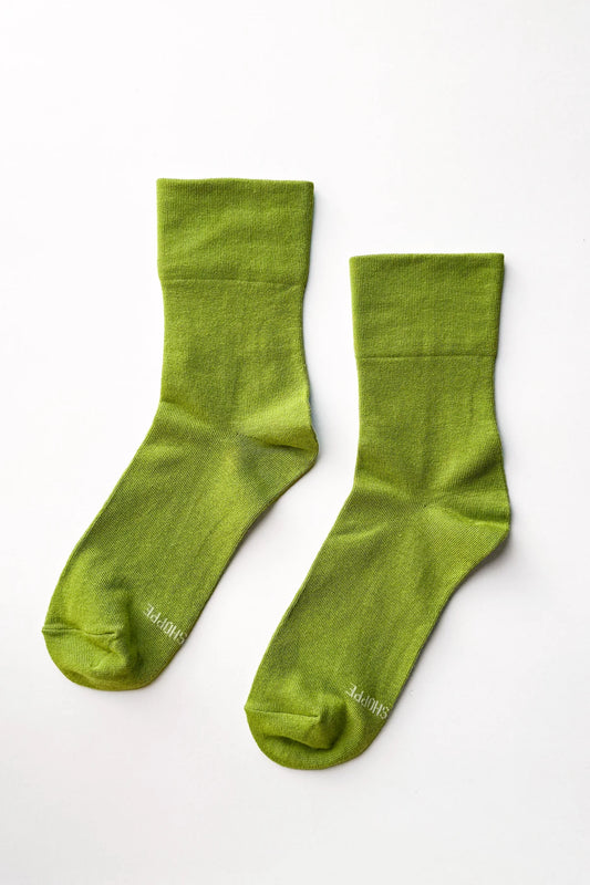 Pair of green socks on a white background
