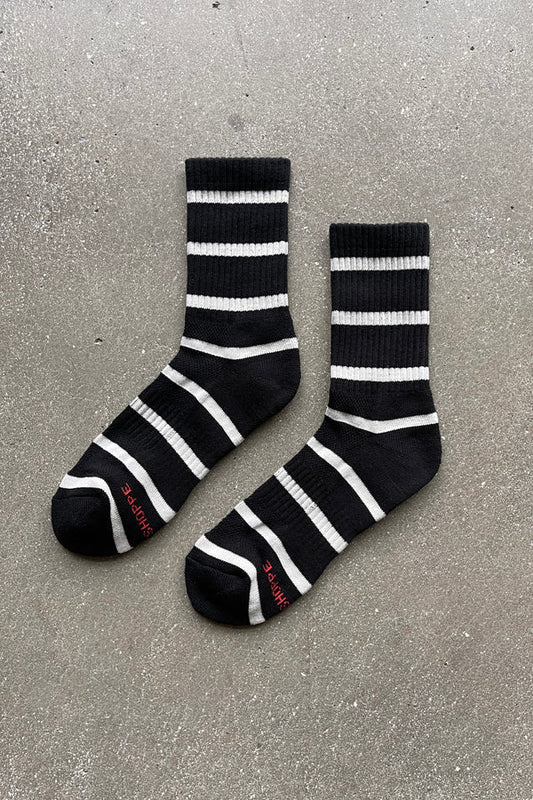 Black and white striped socks on a gray concrete surface