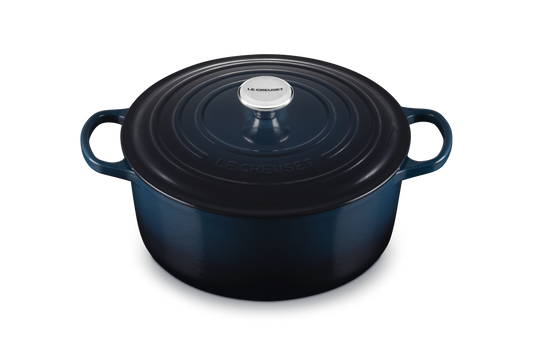 Blue cast iron cookware pot with lid on a white background