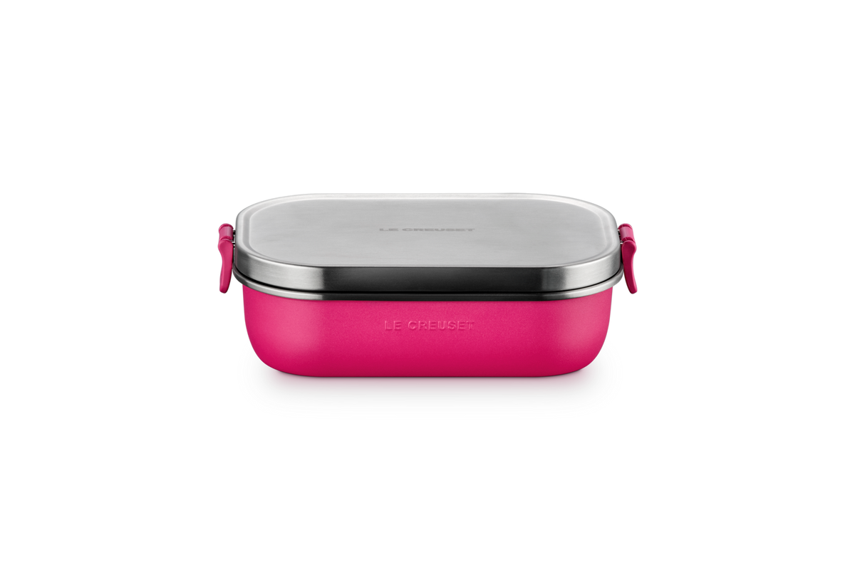 Pink lunch box with silver lid on a white background