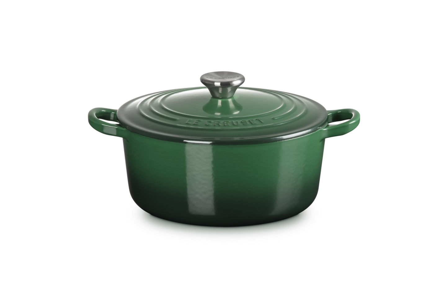 Green enameled cast iron Dutch oven on a white background