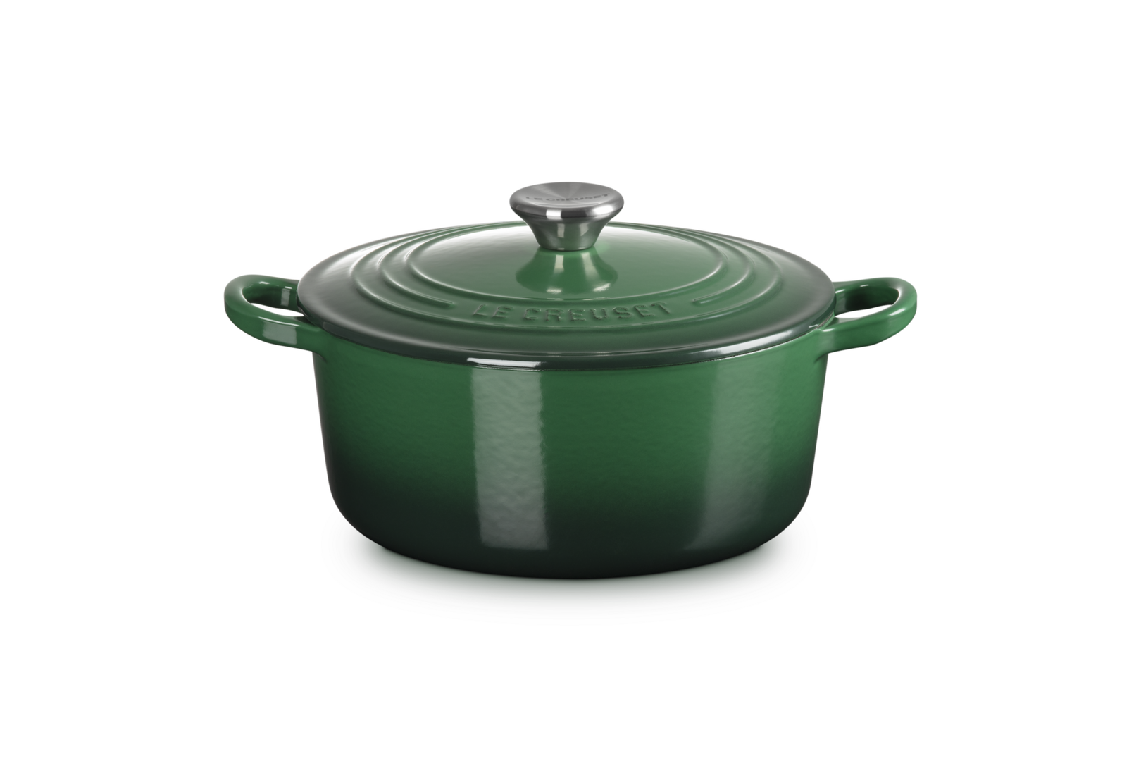 Green enameled cast iron Dutch oven on a white background