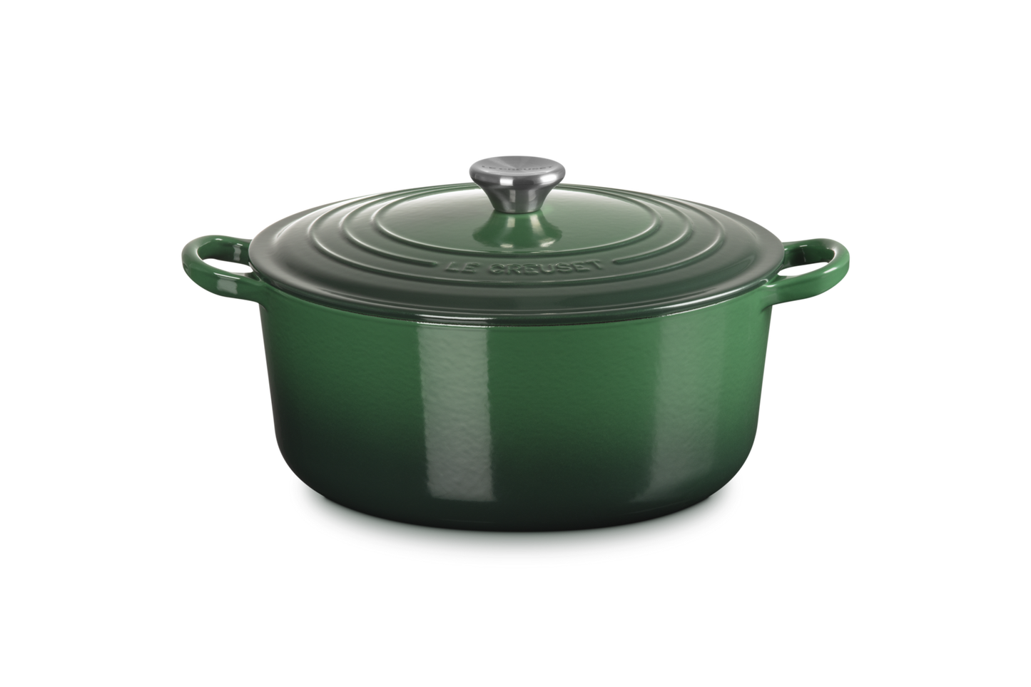 Green enameled cast iron Dutch oven with lid on a white background