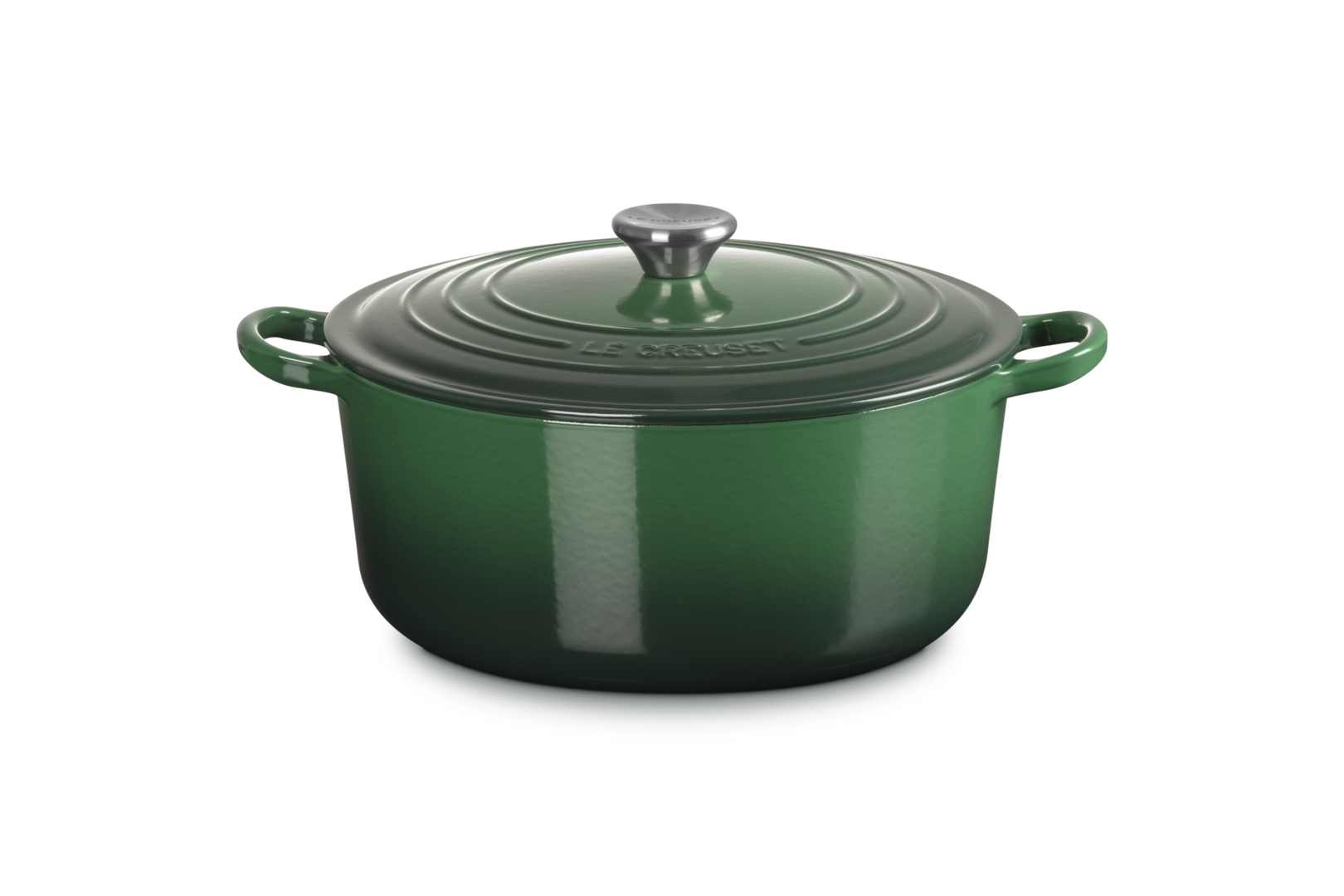 Green enameled cast iron Dutch oven with lid on a white background