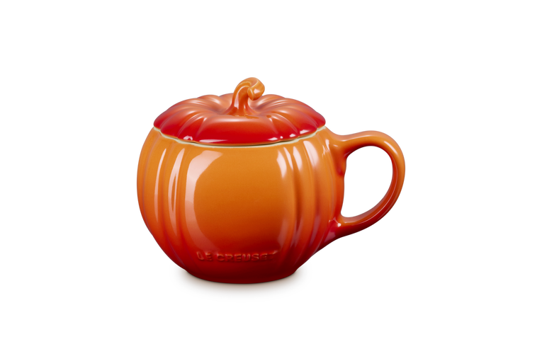 Orange ceramic mug shaped like a pumpkin on a white background