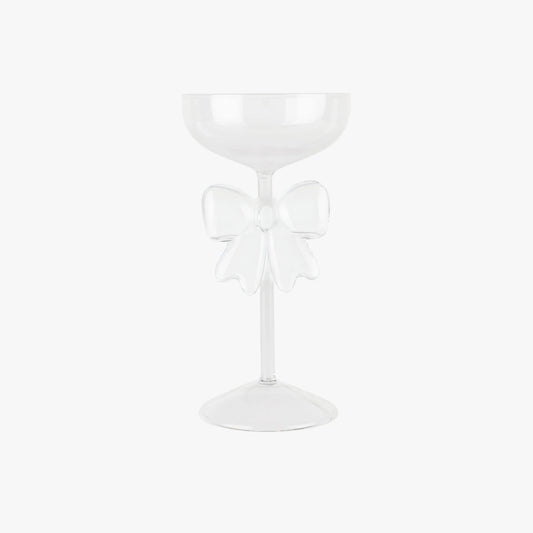 White glass with a decorative bow on a white background