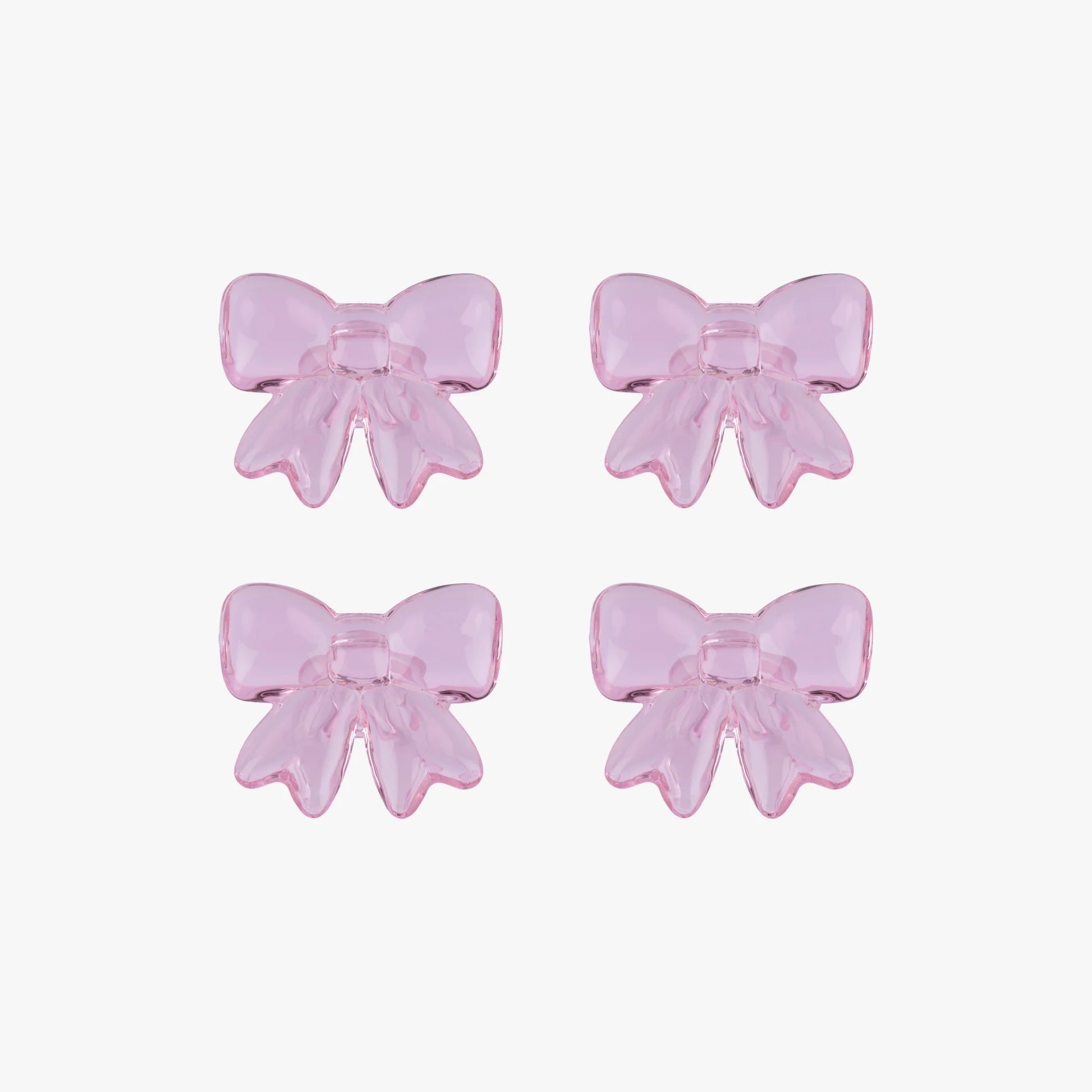 Four pink glass bows on a white background