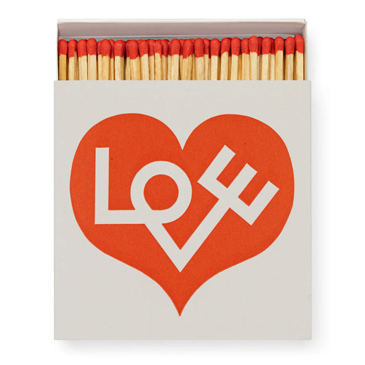 Matchbox with red heart design and 'LOVE' text on a white background