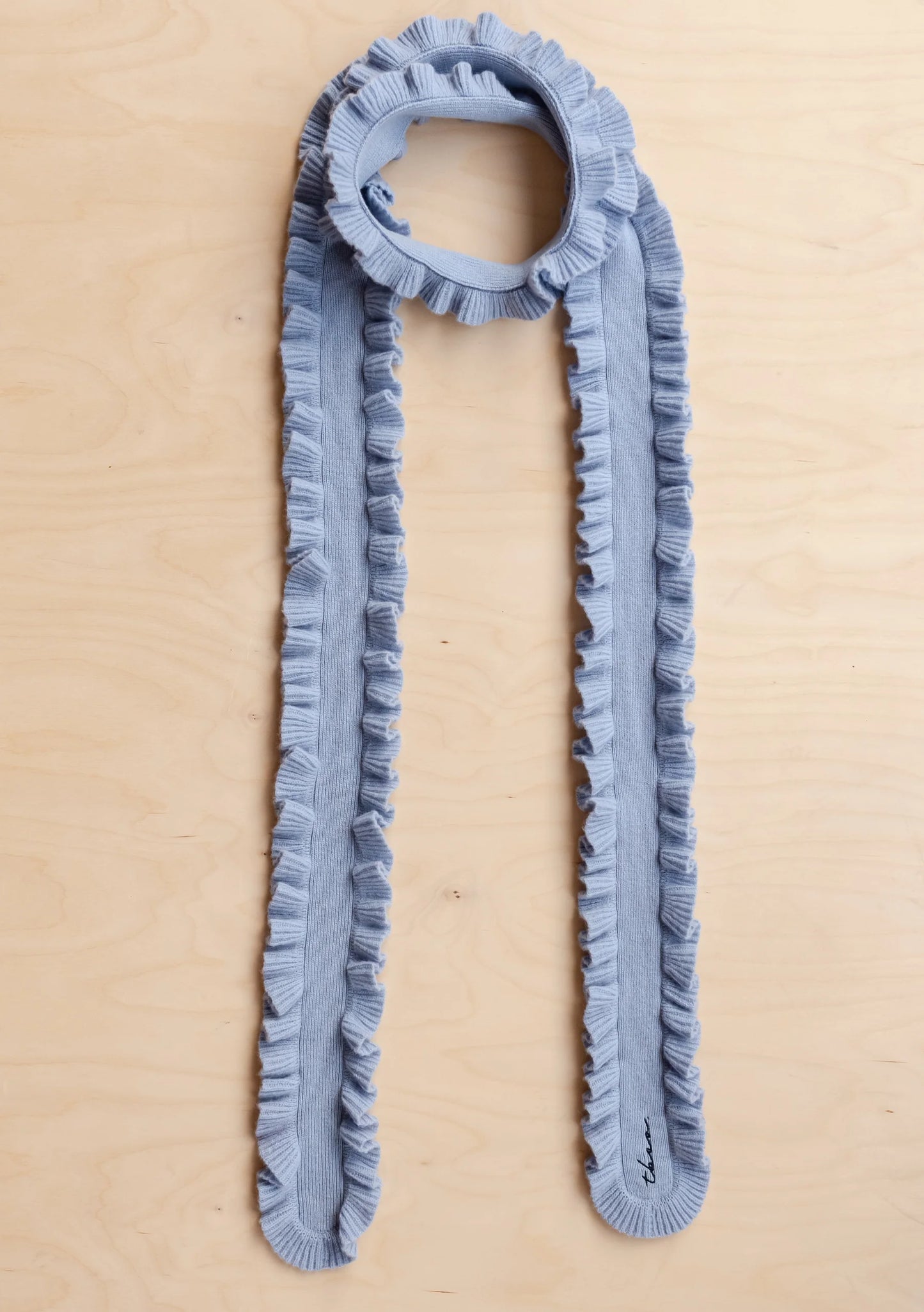 Blue ruffled scarf on a beige background