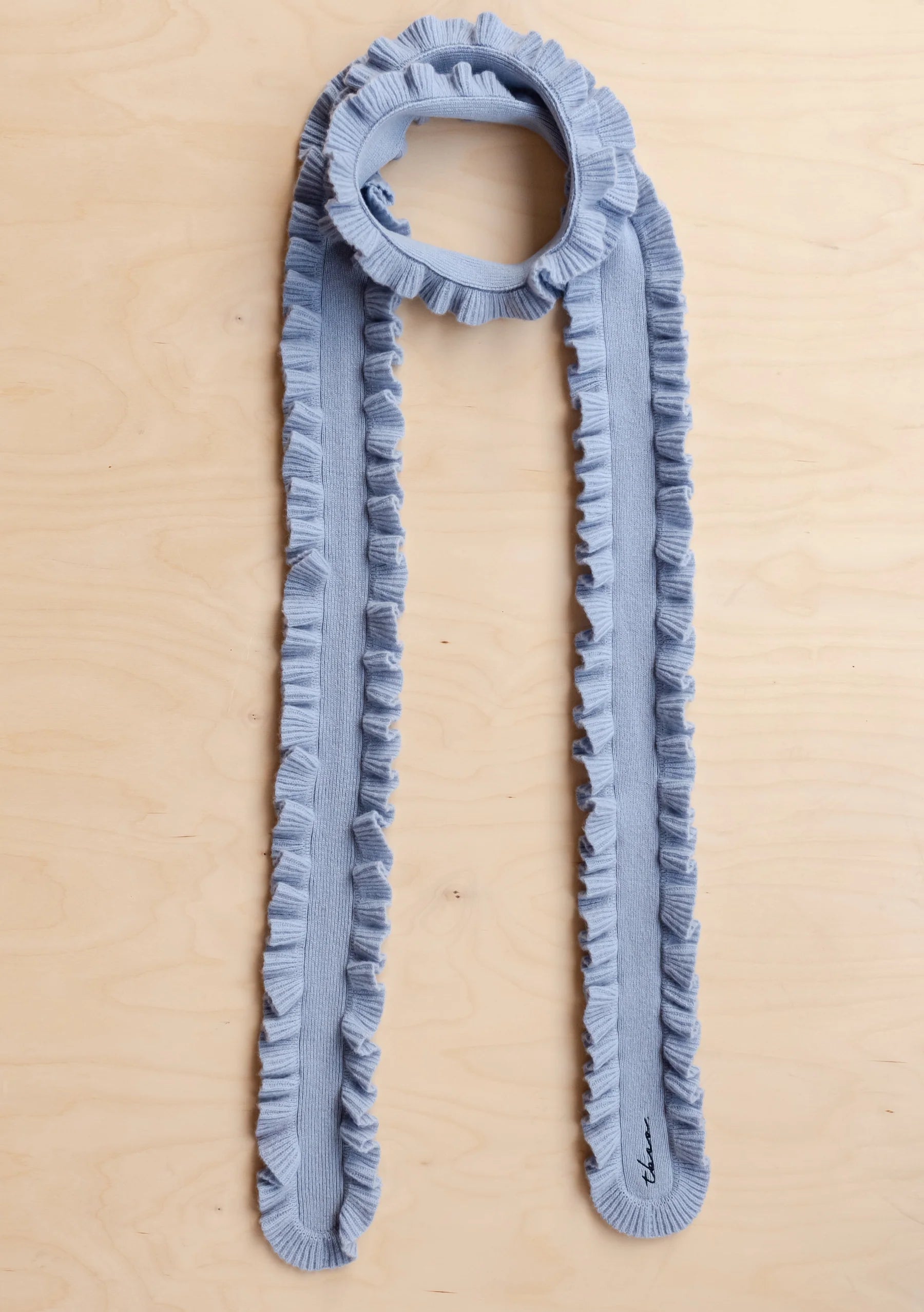 Blue ruffled scarf on a beige background