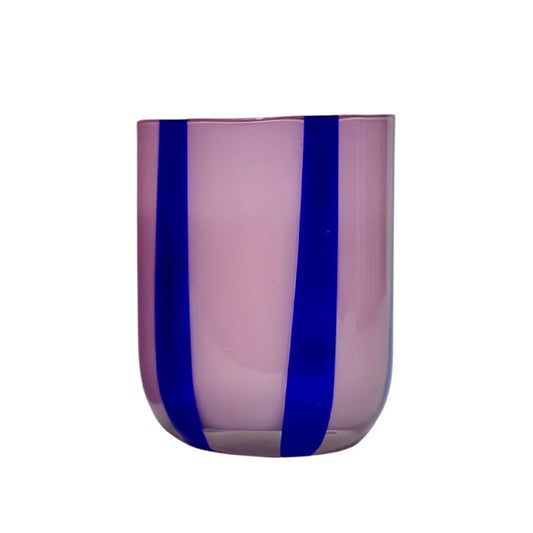 Pink glass tumbler with blue stripes on a white background