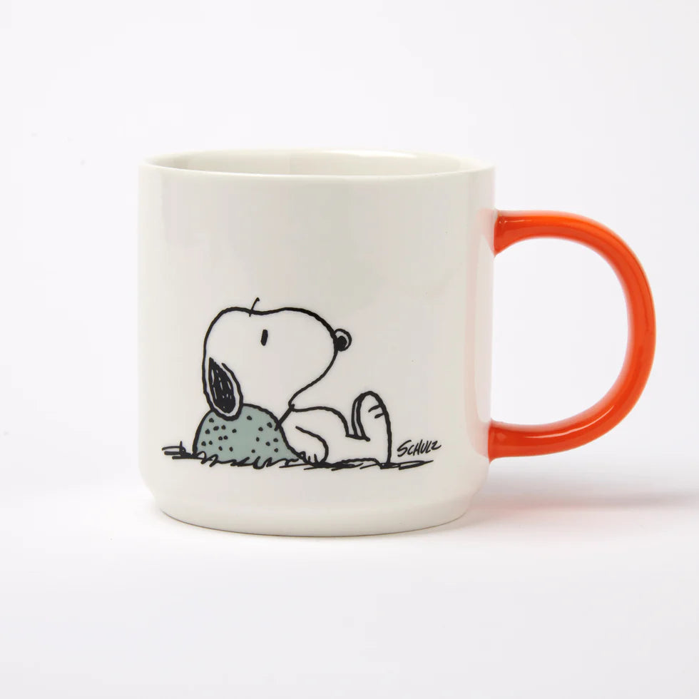 White mug with orange handle featuring a cartoon dog design on a white background