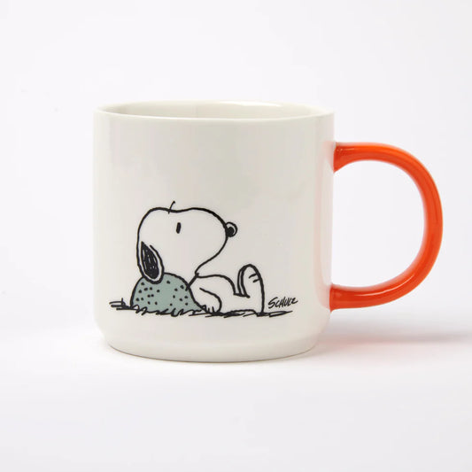 White mug with orange handle featuring a cartoon dog design on a white background