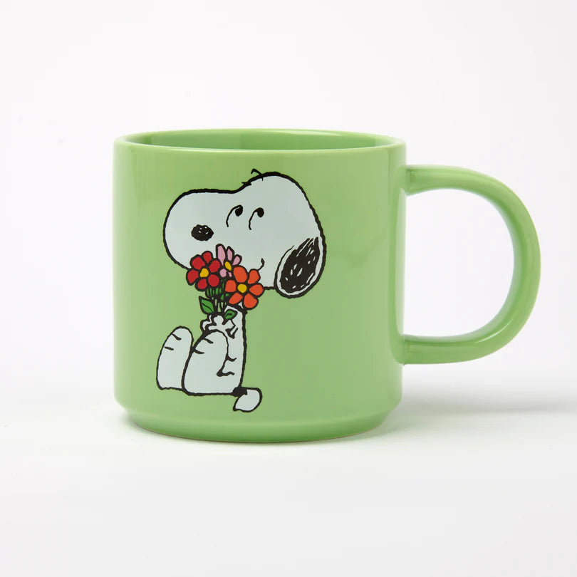 Green mug with a cartoon character holding flowers on a white background
