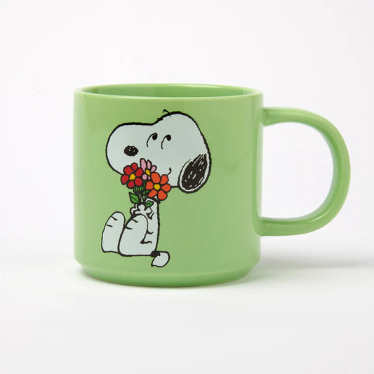 Green mug with a cartoon character holding flowers on a white background