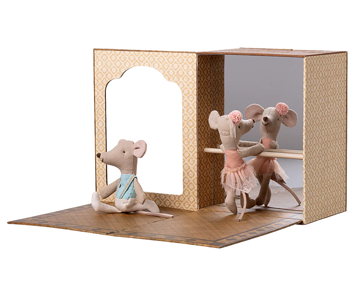 Toy mouse figures in a display dance studio case with a white background