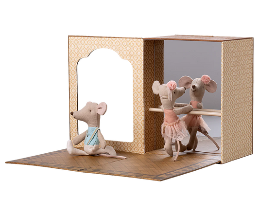 Toy mouse figures in a display dance studio case with a white background