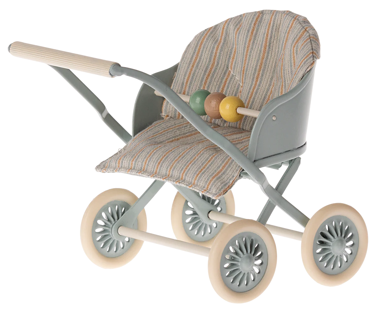Toy stroller with patterned seat and colorful ball on a white background