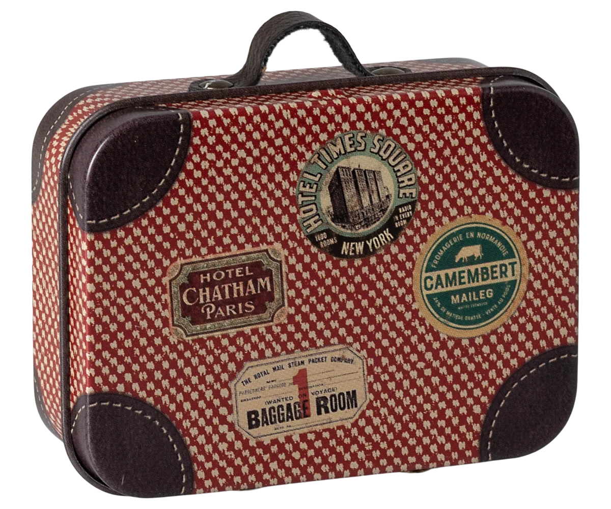 Red and brown checkered suitcase with vintage-style labels on a white background