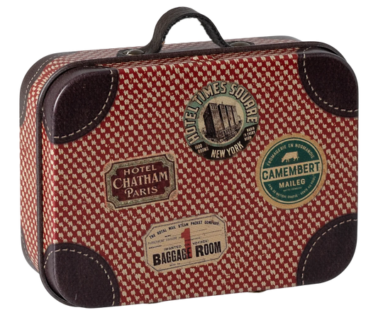 Red and brown checkered suitcase with vintage-style labels on a white background