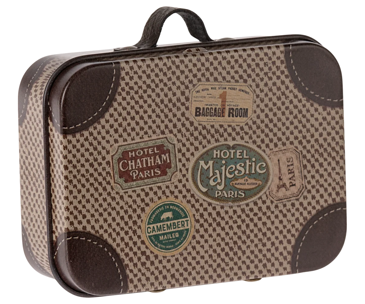 A vintage-style suitcase decoration or miniature suitcase with a brown and beige houndstooth pattern, faux leather trim, and multiple colorful travel ticket stickers on the front.