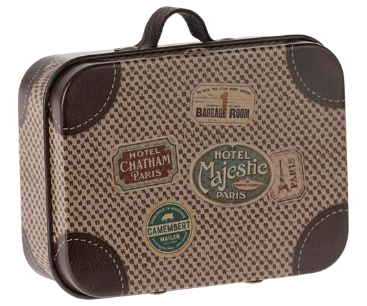 A vintage-style suitcase decoration or miniature suitcase with a brown and beige houndstooth pattern, faux leather trim, and multiple colorful travel ticket stickers on the front.