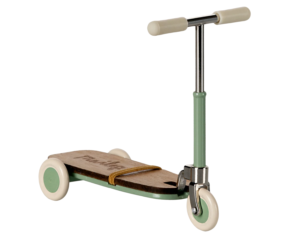 Children's scooter with a green handlebar and white wheels on a white background