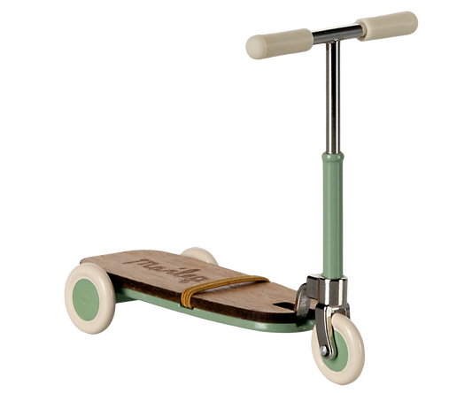 Children's scooter with a green handlebar and white wheels on a white background