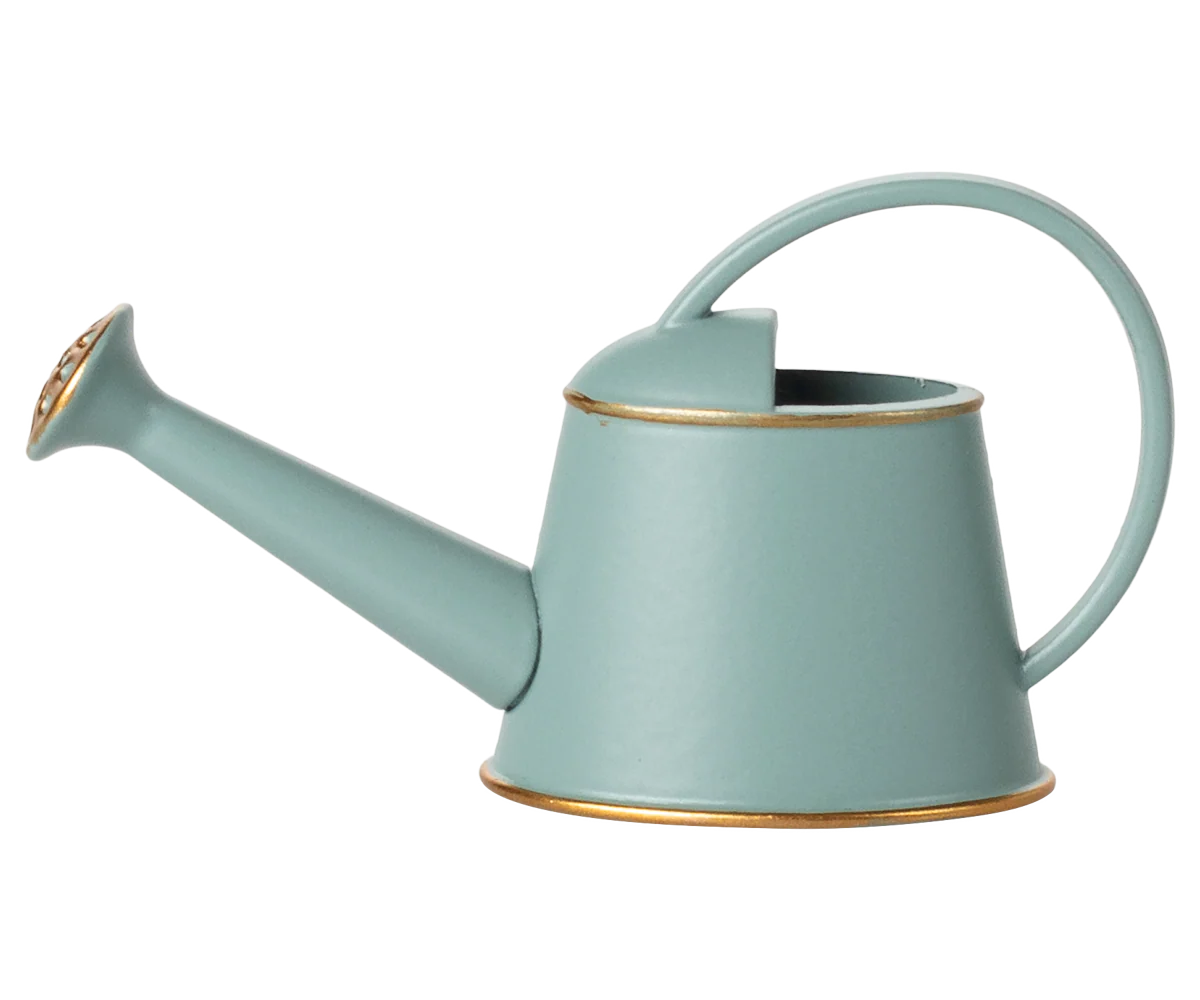 Light blue watering can with gold accents on a white background